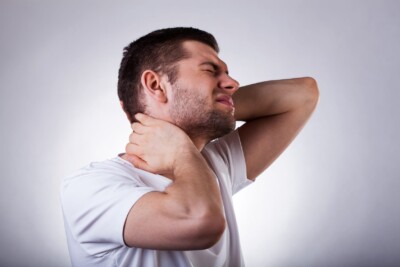 A young man with neck and head pain may need treatment for TMJ in Burke Virginia